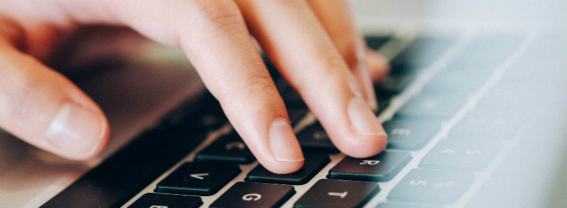 Close up of a hand on a computer keyboard.